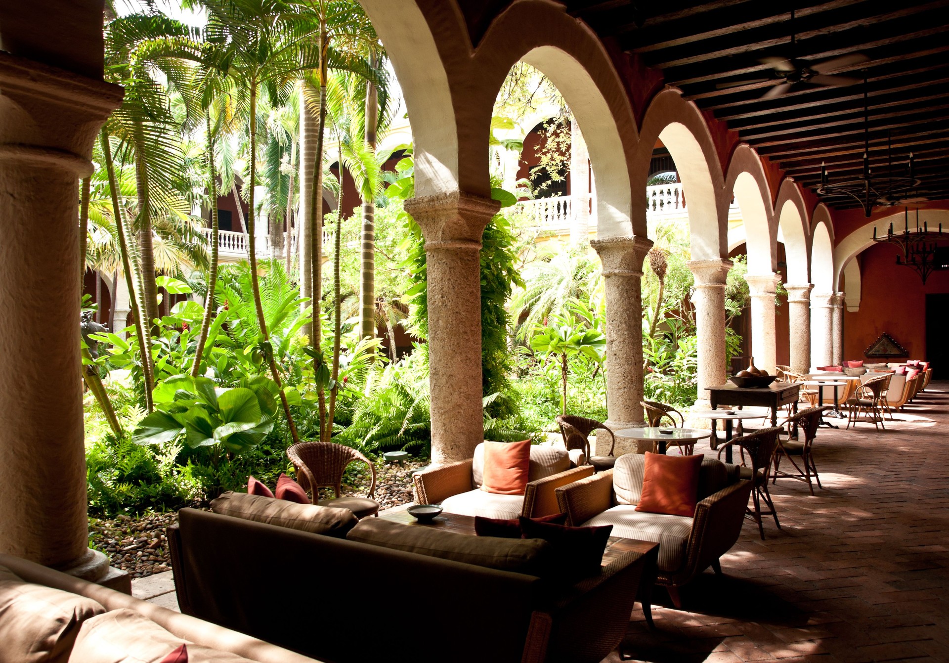 colonial architecture: lush courtyard with tables around it