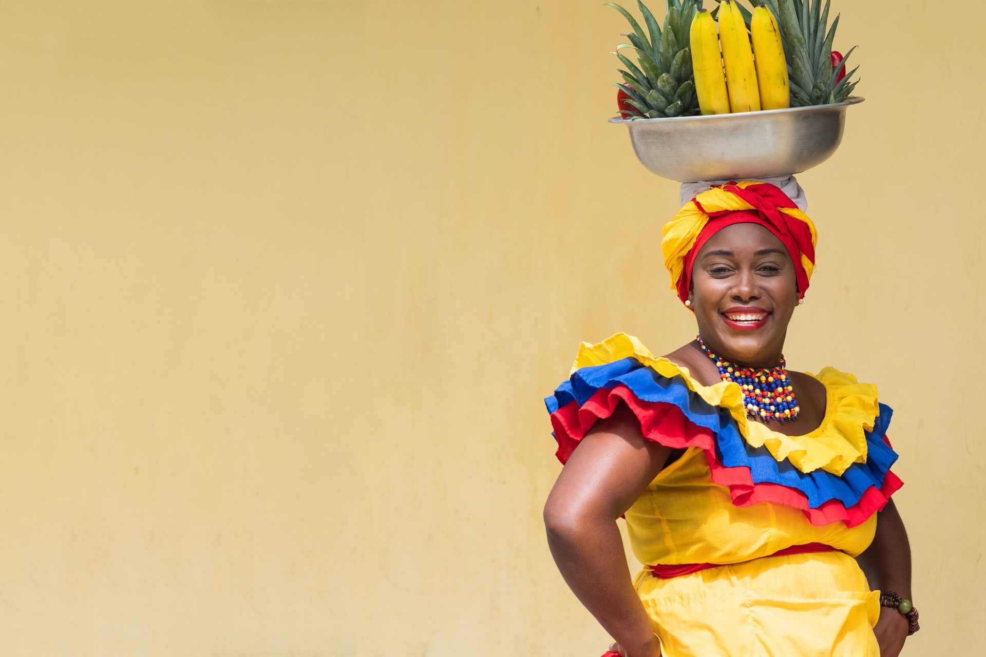 Happy Smiling Fresh Fruit Street Vendor aka Palenquera in Cartagena, Colombia, Afro-Caribbean Woman in Traditional Clothing